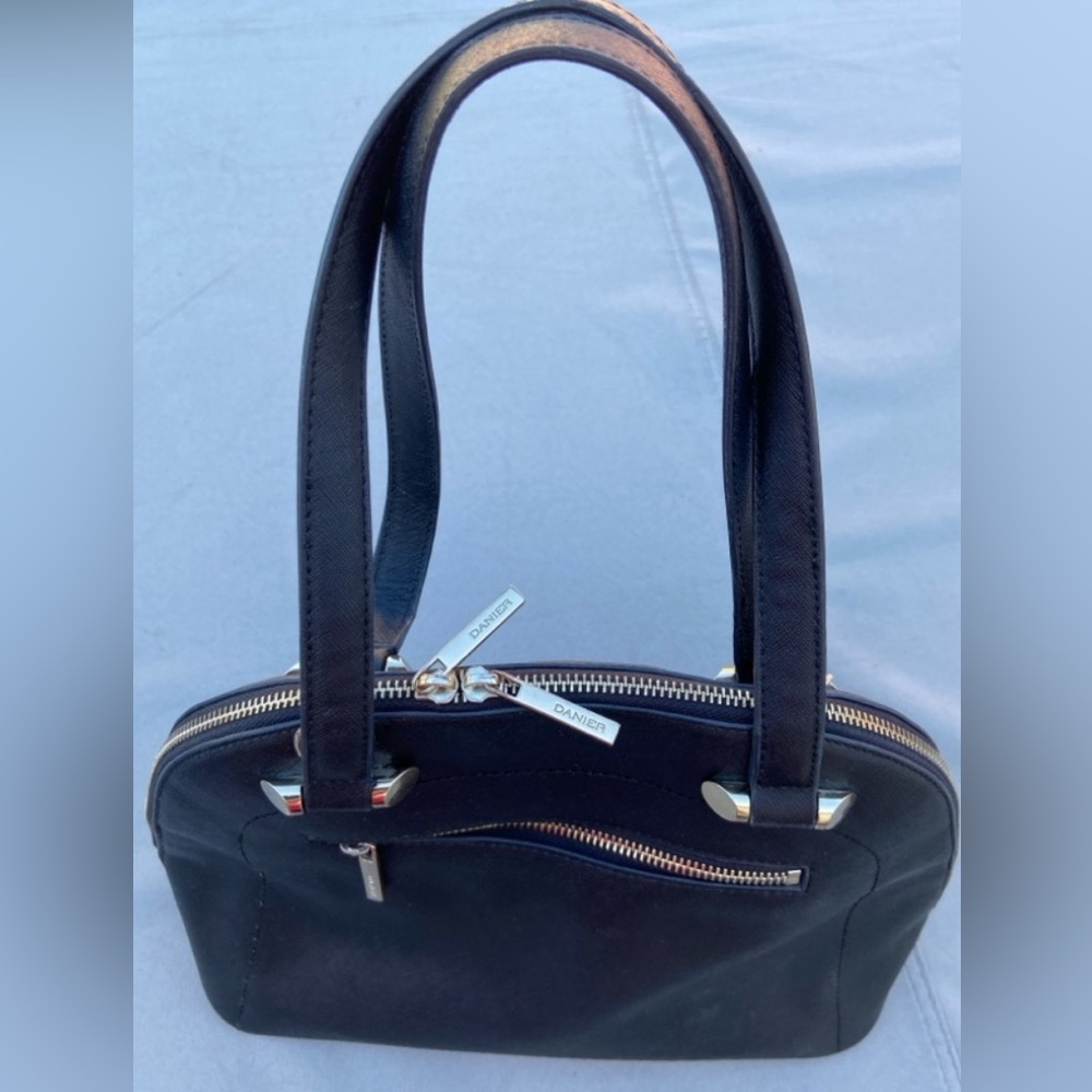 Danier black leather handbag with shiny gold colored accents